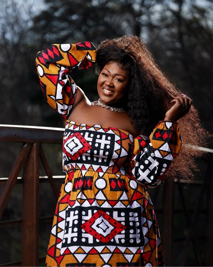 Portrait — colorful print dress on bridge