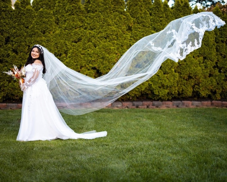 Bridal portrait with veil flying in the breeze
